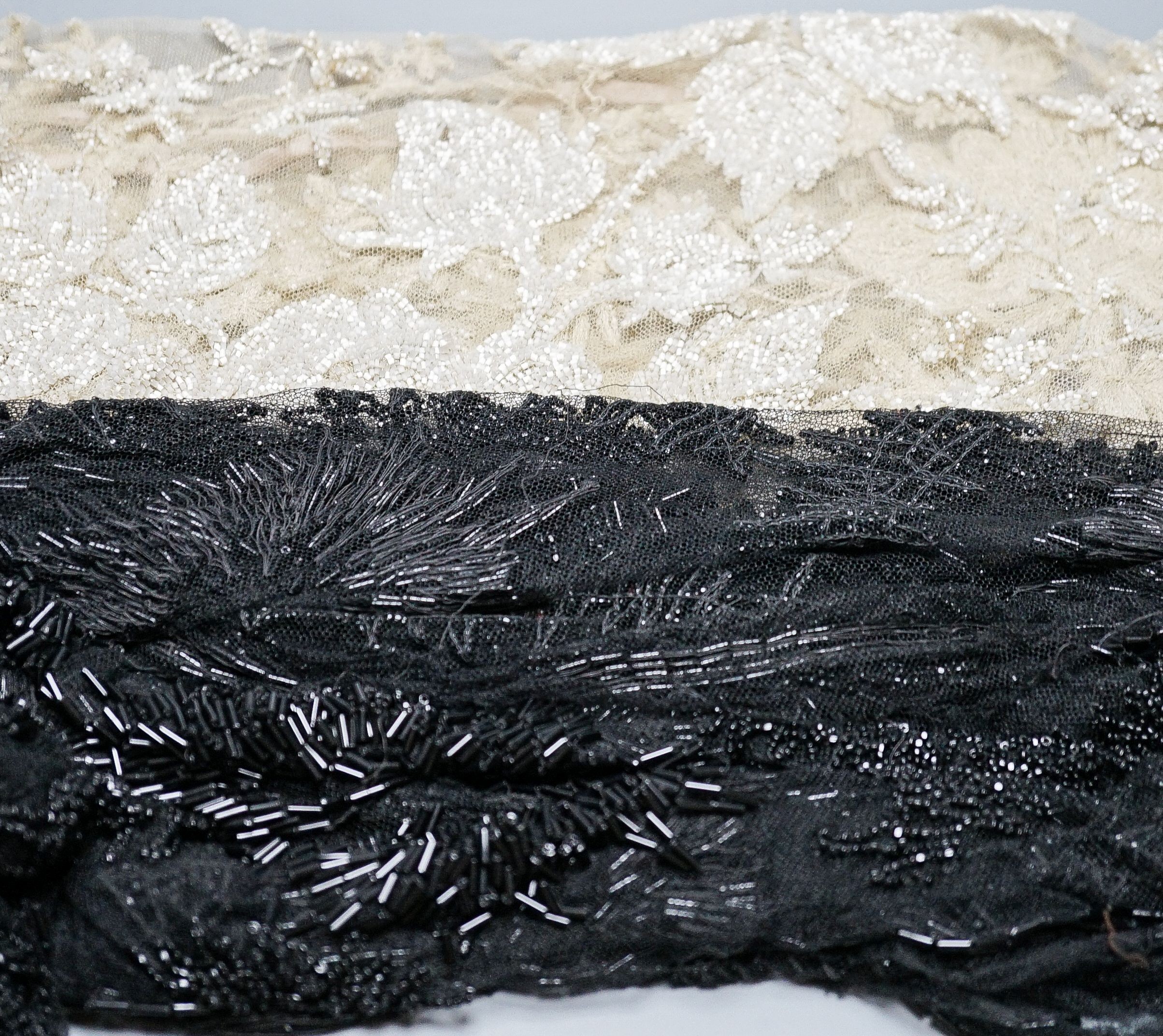 A collection of Edwardian and later sequin and beaded panels on net, a black beaded stole, various buttons etc.
